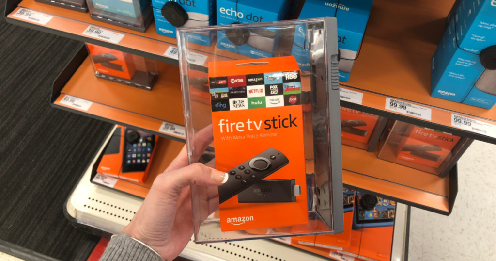 woman's hand holding streaming tv stick in store