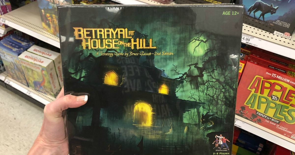 woman holding Betrayal at House on the Hill game